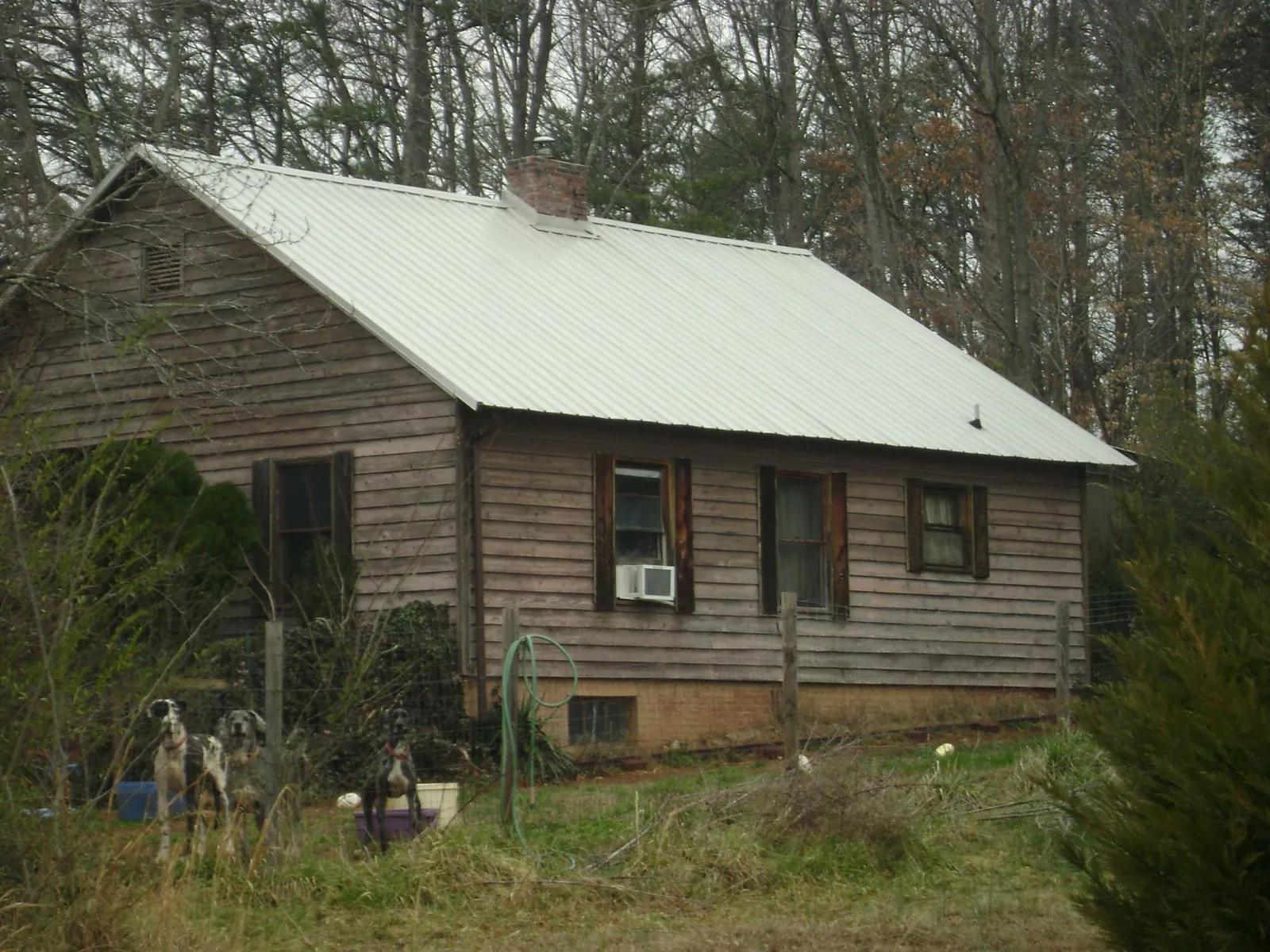 White metal roof on an old wood sided farmhouse, from a Metal Roof Installation job in Berne